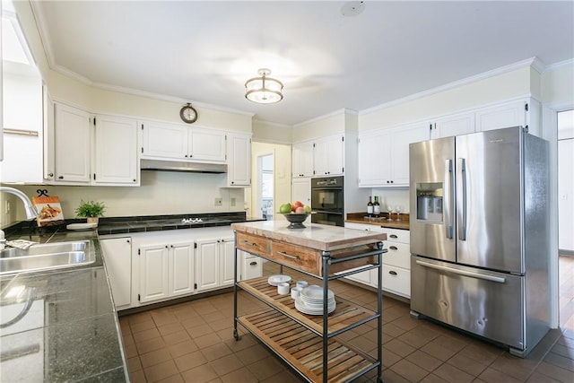 kitchen featuring under cabinet range hood, a sink, white cabinetry, ornamental molding, and stainless steel refrigerator with ice dispenser