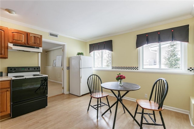 dining area with ornamental molding, light wood finished floors, visible vents, and baseboards