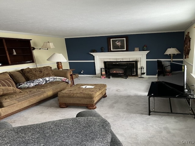 carpeted living room featuring a tile fireplace, crown molding, a textured ceiling, and baseboards