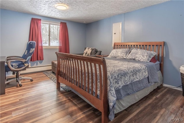 32702 Old Town Springs Rd, Clayton, NY 13622 - bedroom featuring baseboards, a textured ceiling, wood finished floors, and a baseboard radiator