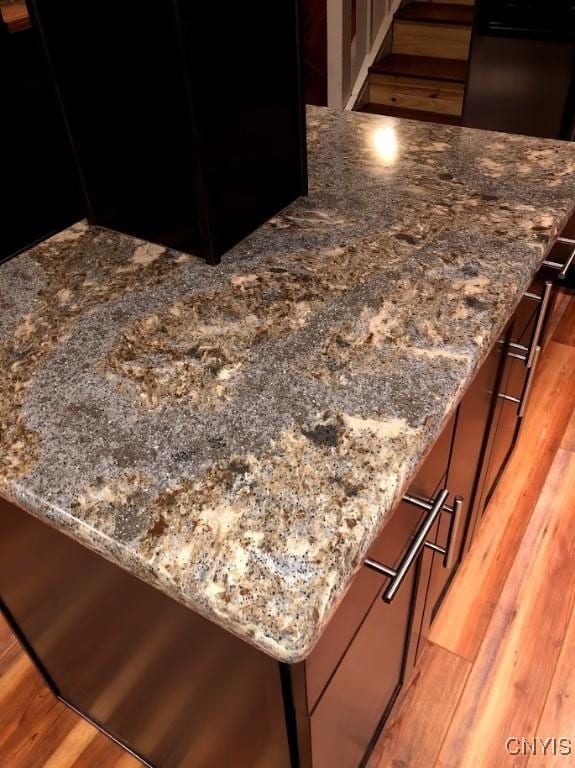32702 Old Town Springs Rd, Clayton, NY 13622 - details featuring dark stone counters and light wood-type flooring
