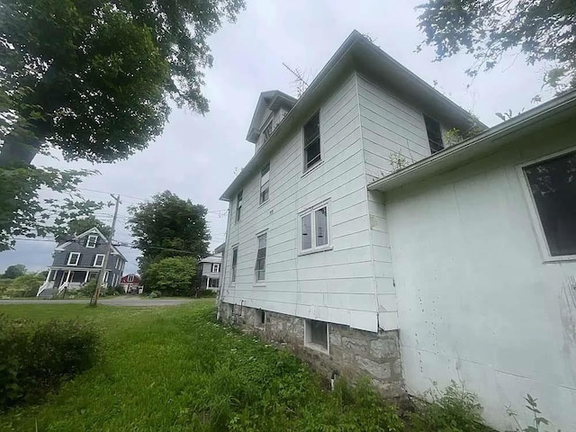 view of side of property with a lawn