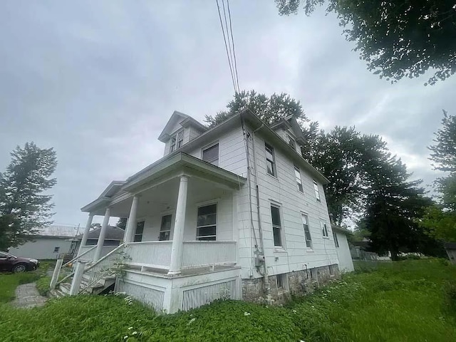 view of side of property with a porch