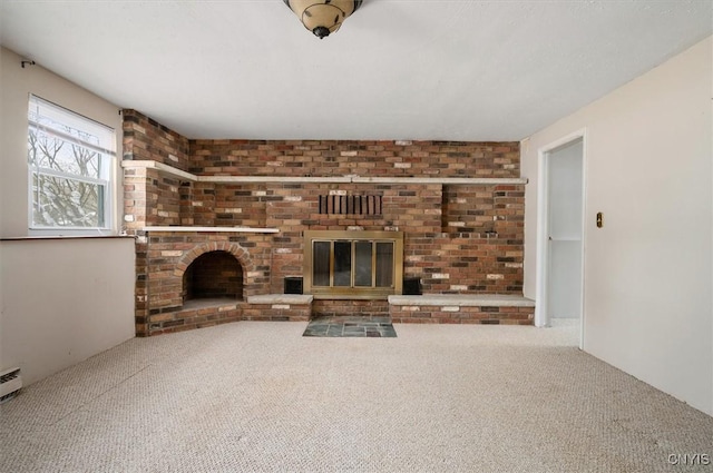 unfurnished living room with a fireplace and carpet flooring