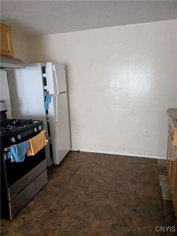 1509 Sunset Ave, Utica, NY 13502 - kitchen featuring gas stove, under cabinet range hood, and baseboards