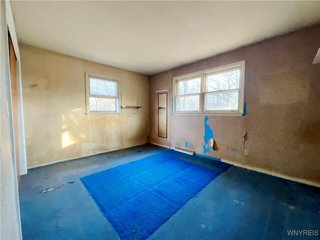 workout room featuring baseboard heating