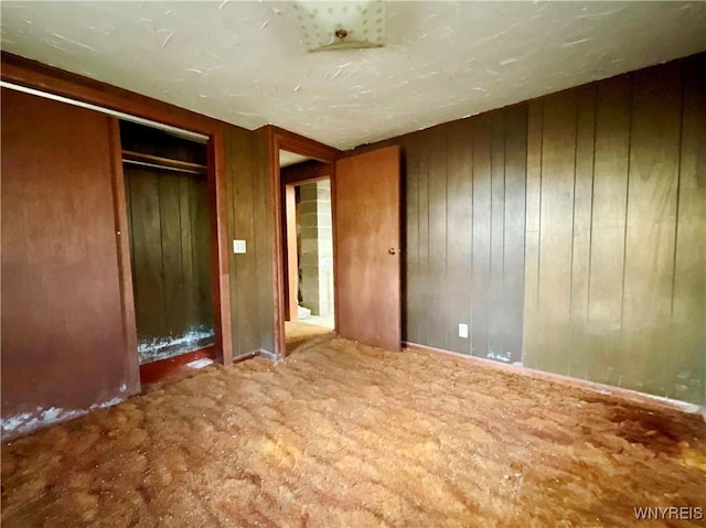 unfurnished bedroom with wooden walls