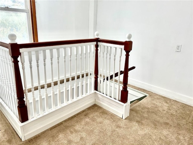 staircase with carpet floors and baseboards