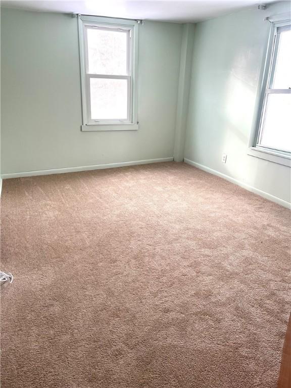 carpeted spare room with baseboards