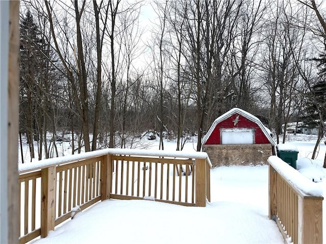 snow covered deck featuring a garage