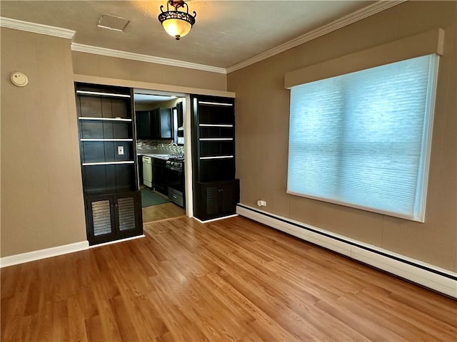 empty room with baseboards, a baseboard heating unit, wood finished floors, and ornamental molding