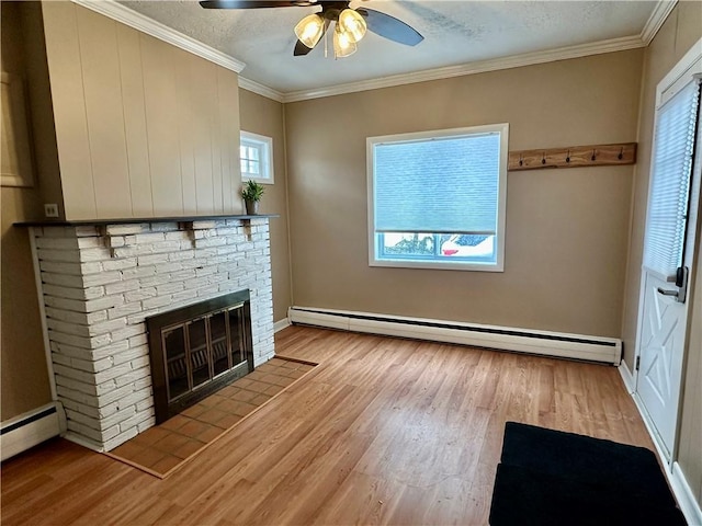 unfurnished living room featuring ornamental molding, baseboard heating, and light wood-type flooring