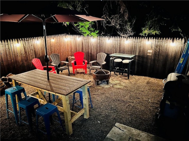 view of patio featuring a fenced backyard and a fire pit