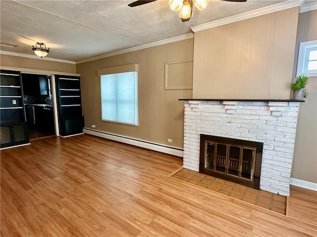 unfurnished living room featuring a textured ceiling, a baseboard radiator, a fireplace, wood finished floors, and ornamental molding