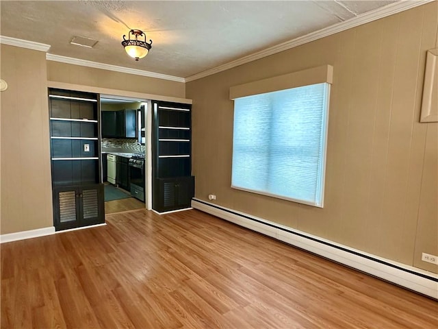 interior space featuring baseboard heating, wood finished floors, and crown molding