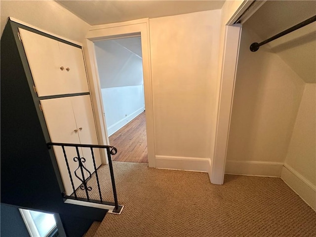 hallway with carpet and baseboards