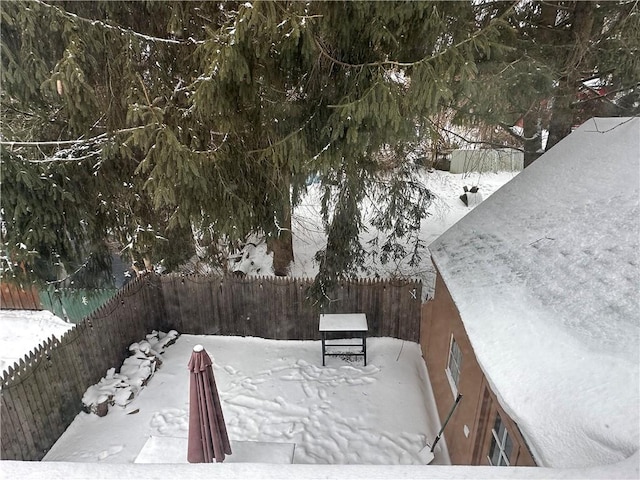 snowy yard with fence