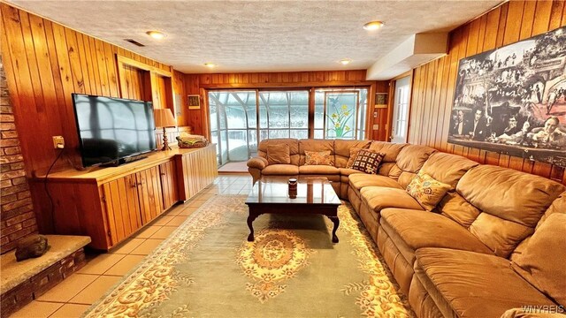 6539 Plum Creek Rd, Mansfield, NY 14731 - living room with wood walls, a textured ceiling, and light tile patterned floors