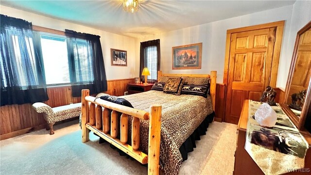 6539 Plum Creek Rd, Mansfield, NY 14731 - bedroom featuring a wainscoted wall, light colored carpet, and wooden walls