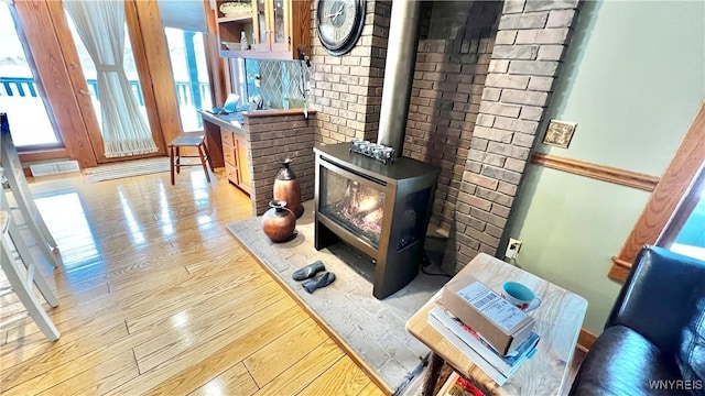 details featuring a wood stove and wood finished floors