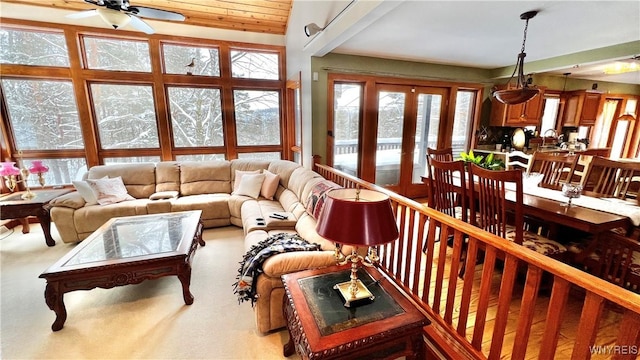 living room with a ceiling fan and light colored carpet