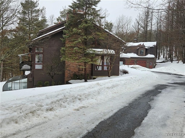 view of snow covered exterior with a garage