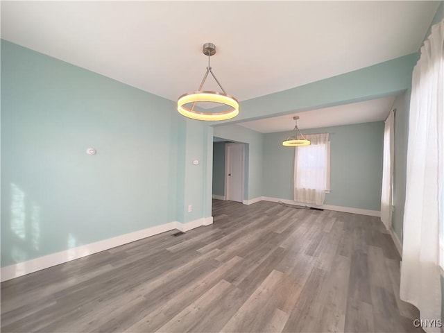 unfurnished room with wood finished floors and baseboards