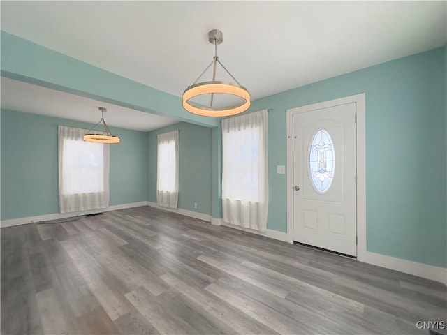 foyer featuring wood finished floors and baseboards