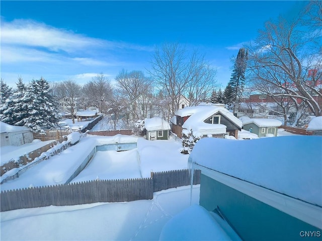 yard covered in snow featuring fence