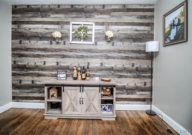 bar with baseboards and wood finished floors