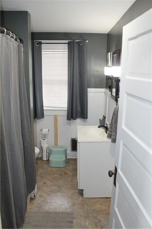 bathroom featuring vanity and toilet