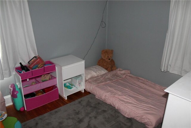 bedroom featuring dark wood finished floors