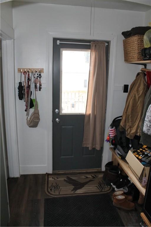 doorway with dark wood-type flooring