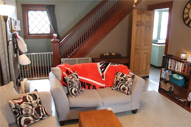 living room with stairway and wood finished floors