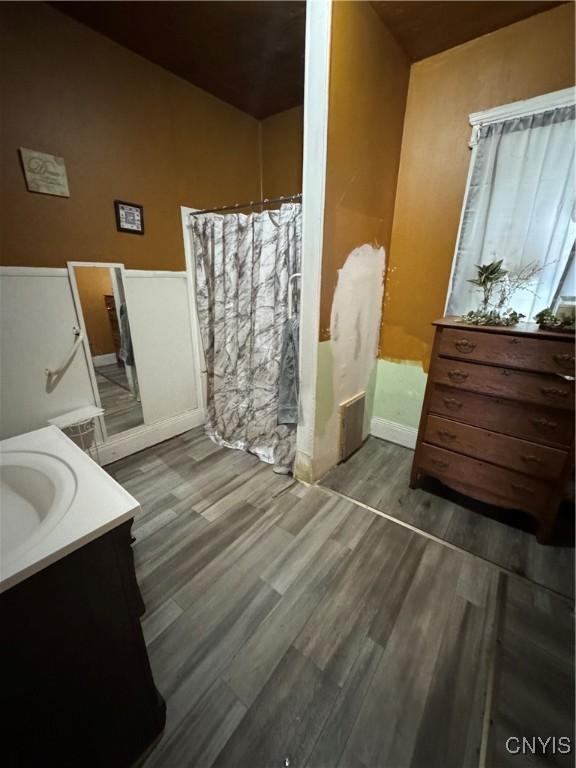 bathroom with vanity and wood finished floors