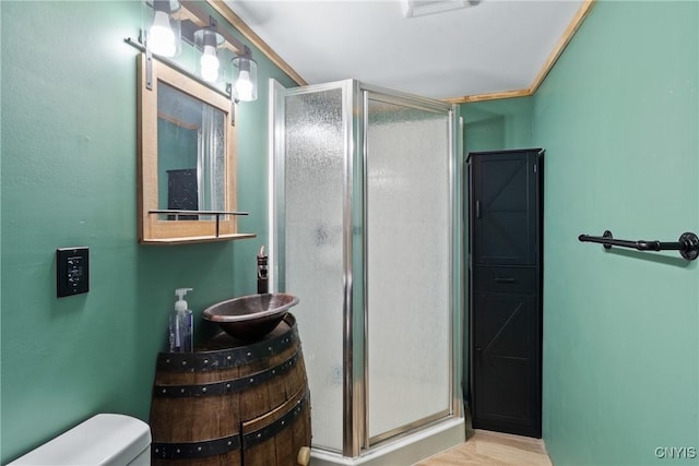 full bathroom with wood finished floors, a stall shower, vanity, and toilet