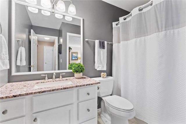 bathroom featuring a shower with shower curtain, vanity, and toilet