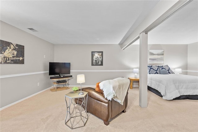 bedroom featuring baseboards, visible vents, and light colored carpet