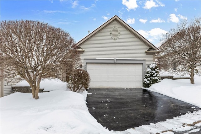 view of snowy exterior with driveway