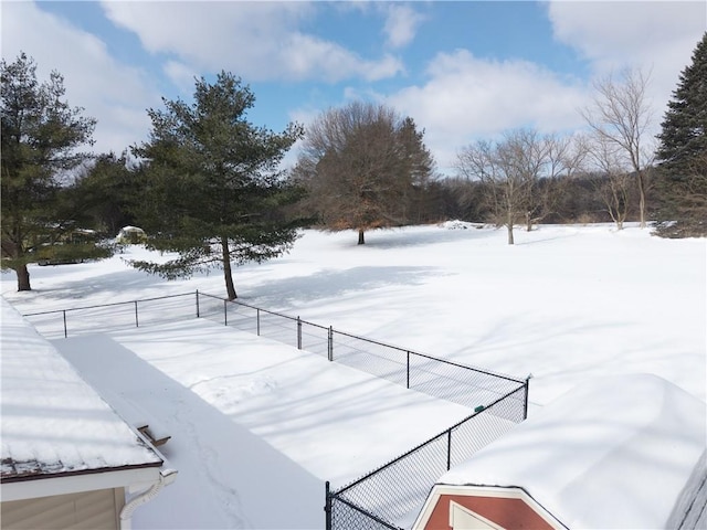 snowy yard with fence