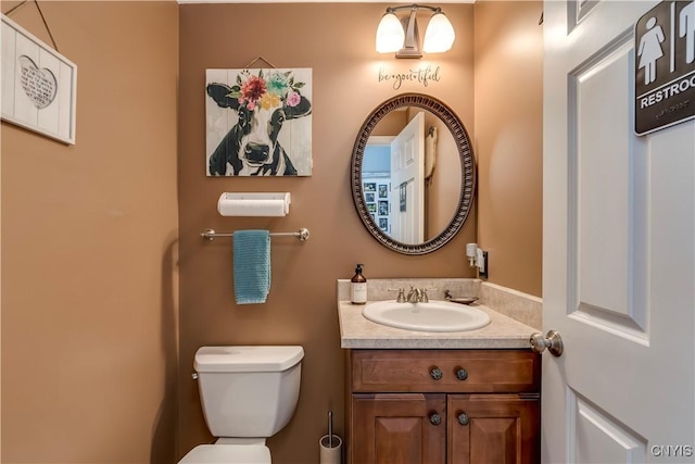 bathroom with toilet and vanity