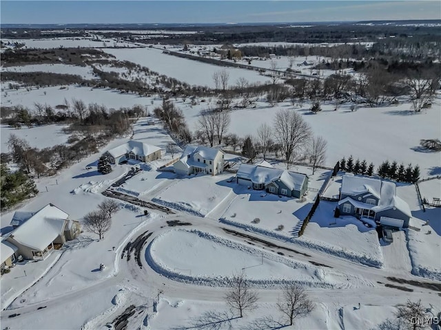 snowy aerial view with a residential view