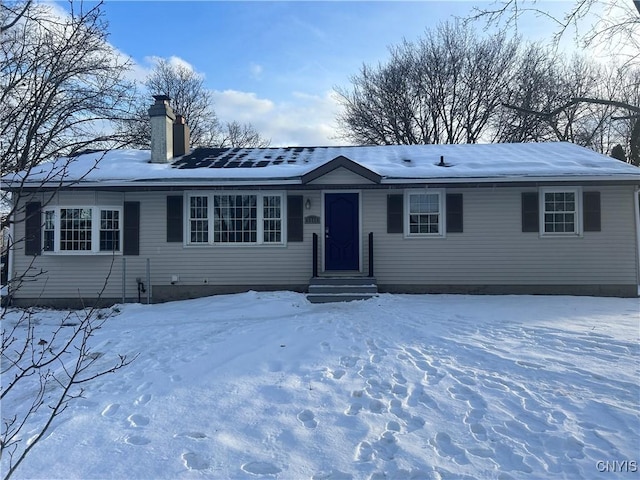 ranch-style home with entry steps and a chimney