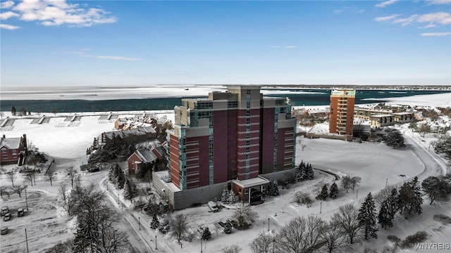 snowy aerial view featuring a water view