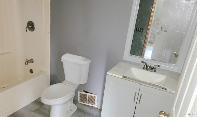 full bath with visible vents, toilet, wood finished floors, tub / shower combination, and vanity