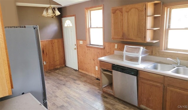 kitchen featuring a sink, light countertops, appliances with stainless steel finishes, open shelves, and decorative light fixtures