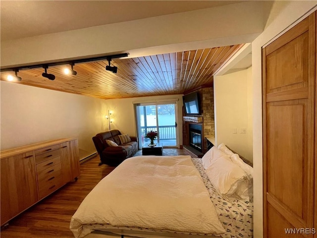 bedroom with wooden ceiling, dark wood-style flooring, access to outside, baseboard heating, and a fireplace