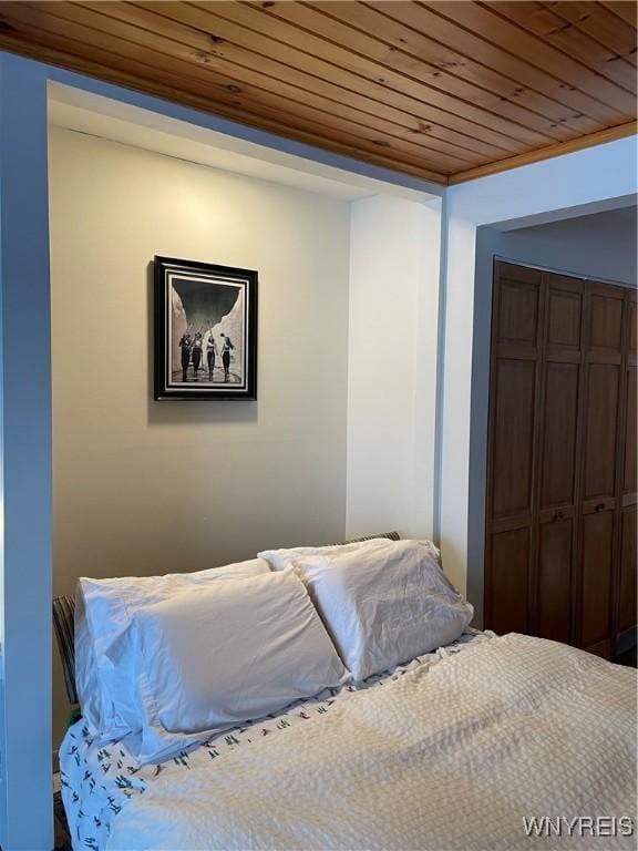 bedroom with a closet and wooden ceiling