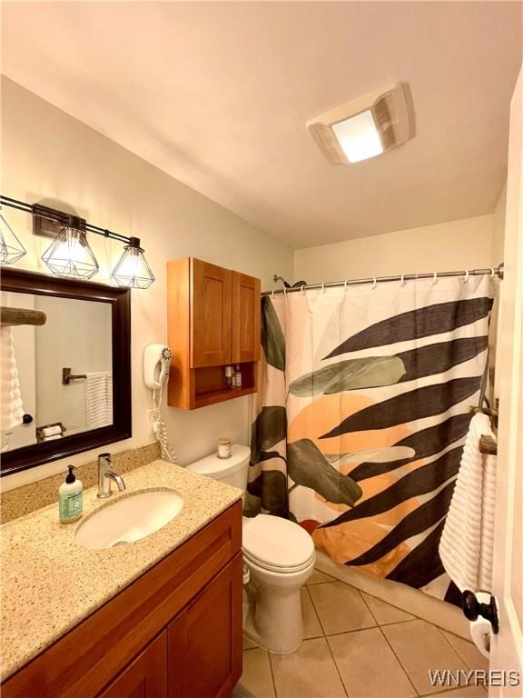 full bathroom featuring vanity, toilet, and tile patterned floors