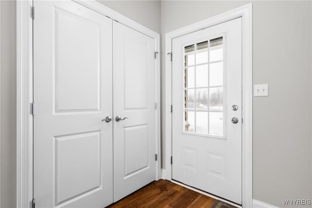 doorway with dark wood-style floors